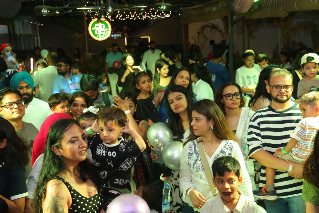 Parents dancing with babies in the neon light