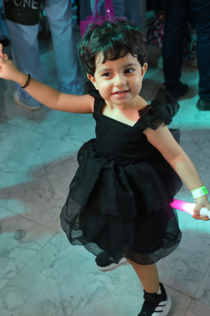 Little girl dancing in a black dress