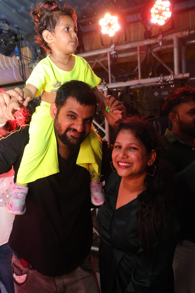 Parents dancing with kids on shoulders